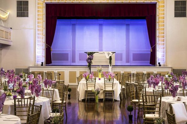 The stage and Bride & Grooms table in the Grande Ballroom. The Grande Ballroom can seat up to 500 people, with room for dance and dinner. With two bars, upstairs and down, a bridal suite, on-floor restrooms, and even a mezzanine overlooking the main floor.